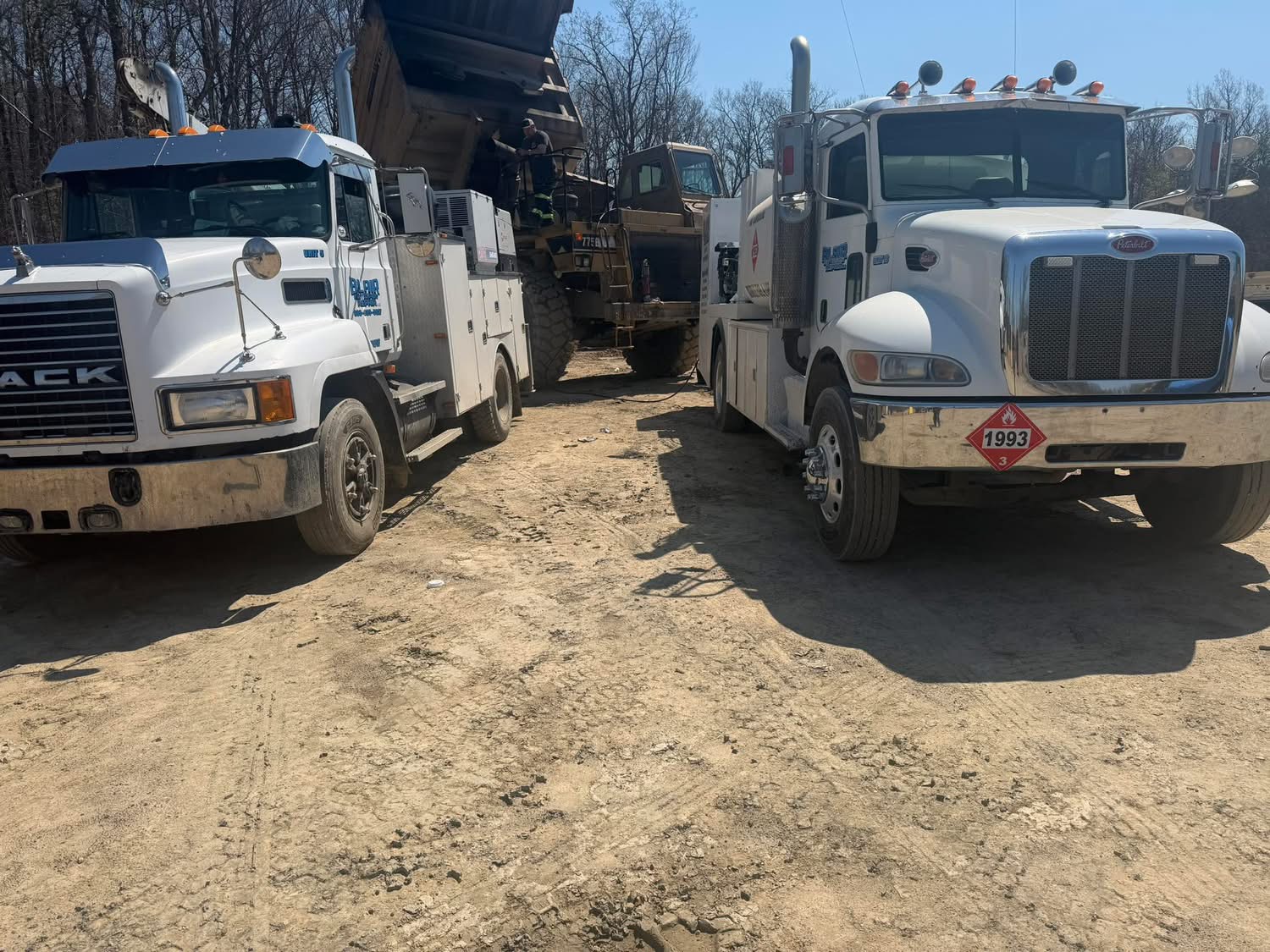 Mobile service trucks working on heavy haul truck in the field