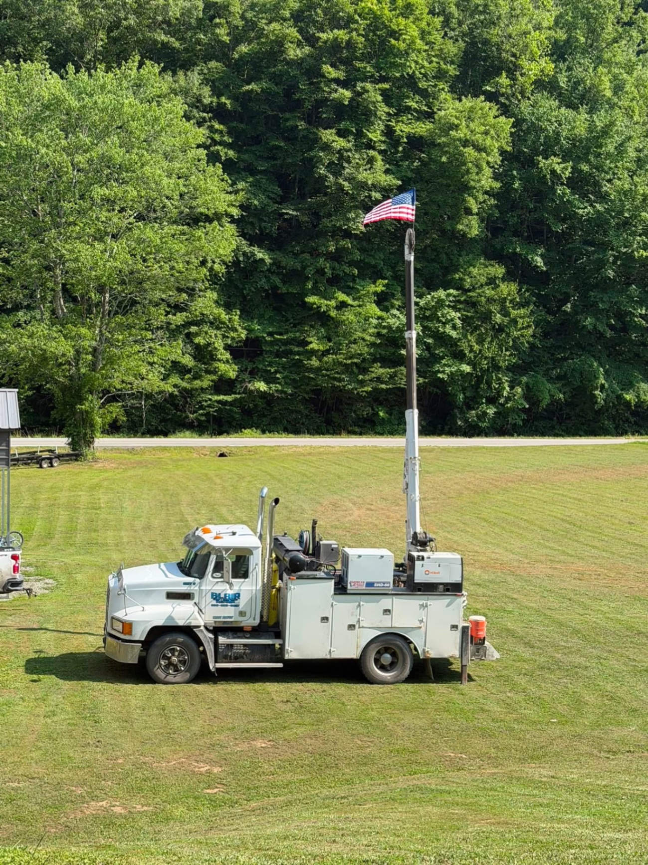 Blair service truck with crane boom and American flag